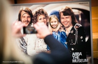 A woman taking photo of ABBA picture. © Anna Bergqvist / Abba The Museum