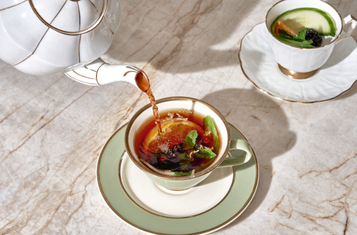 Pimm's Cup cocktail being poured into a teacup at Caffe Dante.