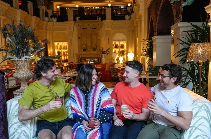 Drew Tillman (@drew_tillman) enjoying cocktails with a group of tourists in the hall of the historic hotel Per La in Downtown LA.