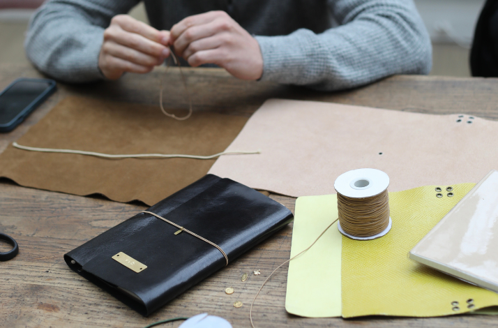 Participant crafting at  Notebook personalization workshop at Hôtel de Lauzun, Paris.